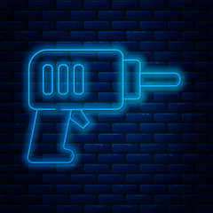 Glowing neon line Electric drill machine icon isolated on brick wall background. Repair tool. Vector