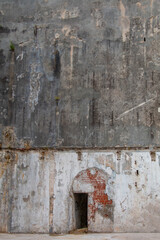 Wall of an old ruined house. Entrance door