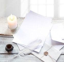 Envelope and paper on white wooden table
