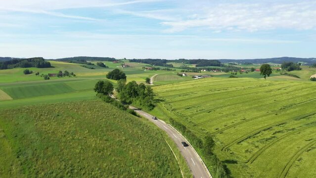 aerial view of a country road in rural area with passenger cars, drone photography