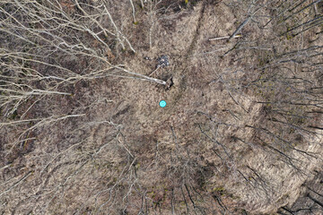 Small drone heliport between tall leafless trees