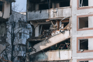Fototapeta na wymiar A strike on a high-rise building in the city of Zaporozhye, Ukraine. A residential building destroyed by an explosion following a Russian missile attack. Consequences of the explosion. Houses in the c