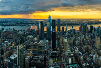 A rain storm over the Hudson Yards in New York City during beautiful sunset.