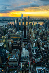 A rain storm over the Hudson Yards in New York City during beautiful sunset. - obrazy, fototapety, plakaty
