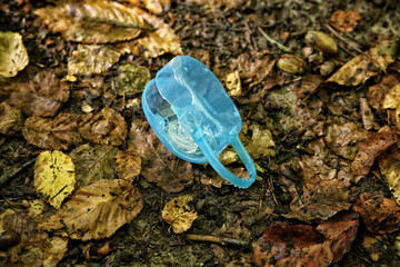 Small plastic blue box with dummy on foliage
