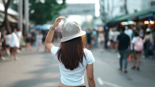 woman traveler visiting in Bangkok, Tourist with hat sightseeing in Chatuchak Weekend Market, landmark and popular attractions in Bangkok, Thailand. Travel in Southeast Asia concept