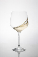 GLASS OF WHITE WINE IN MOTION