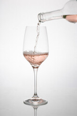 GLASS OF ROSE WINE IN MOTION