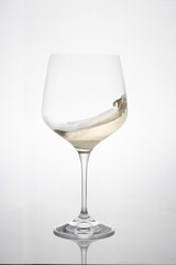 GLASS OF WHITE WINE IN MOTION