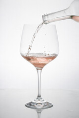 GLASS OF ROSE WINE IN MOTION