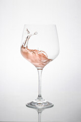 GLASS OF ROSE WINE IN MOTION