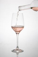 GLASS OF ROSE WINE IN MOTION