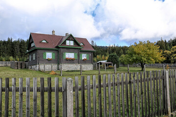 Single timbered cottage with dead fence in fall