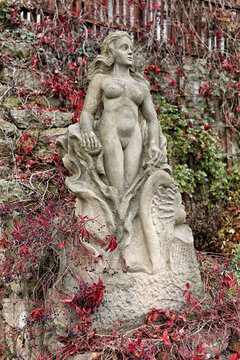 Statue of naked lady in the rock on the garden hill