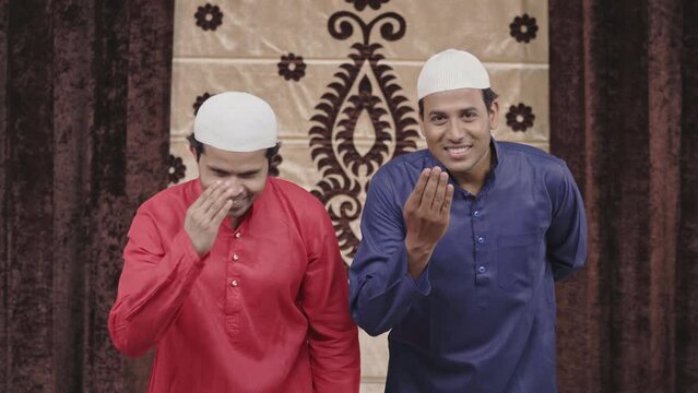 Two muslim men doing Adaab or greetings to the camera