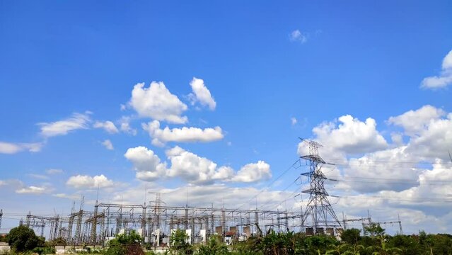 cloud timelipse bright blue sky background. white cloud hyperlipse. movement of clouds over the power substation tower. power supply technology with very high voltage lines. natural scenery in summer.