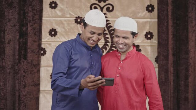 Two muslim men watching videos on youtube