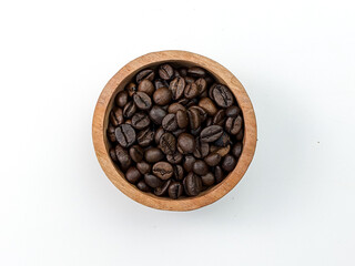top view of coffee beans in wooden bowl isolated on white