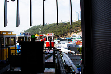Korean people and foreign travelers sitting passengers journey on Sky Capsule Tram Haeundae Blue Line at Mipo Station for travel visit in Haeundae Beach Park at Haeundae gu city in Busan, South Korea