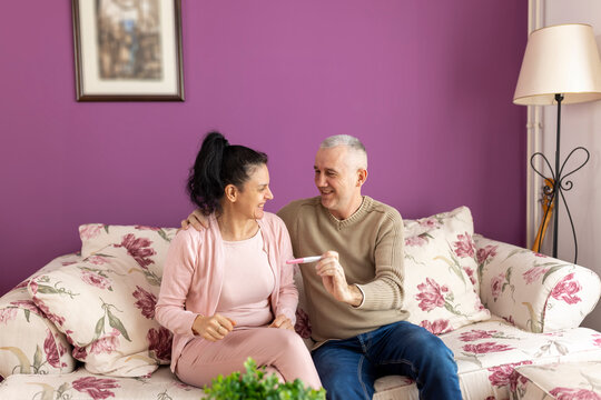 Mature Couple Feeling Happy After Taking A Home Pregnancy Test. Artificial Insemination, Menopause.