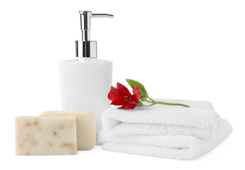 Obraz na płótnie Canvas Soap bars, dispenser and terry towels on white background