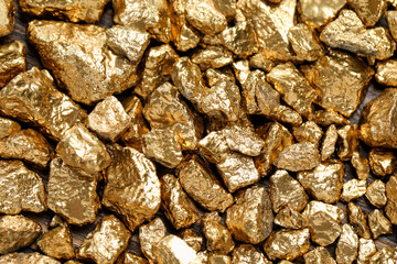 Pile of gold nuggets as background, top view