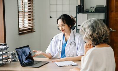 A professional physician talks to discuss results or symptoms and gives a recommendation to a male patient and signs a medical paper at an appointment visit in the clinic..