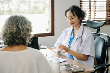 Obraz premium Asian Doctor and patient discussing something while sitting at the table . Medicine concept.