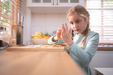 Granddaughter of grandparents in a kitchen with plenty of natural light, Help cook dinner for the day for the family.