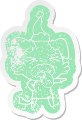 cartoon distressed sticker of a disgusted dog wearing santa hat