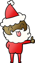 man with beard sticking out tongue wearing santa hat