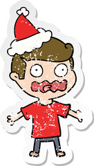 distressed sticker cartoon of a man totally stressed out wearing santa hat