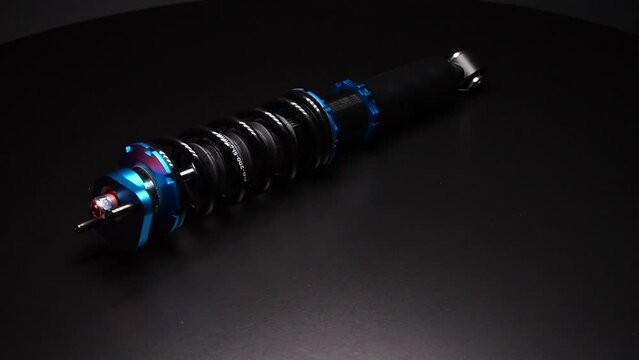 auto suspension tuning coilovers shock absorbers and springs blue for a sports drift car on a dark background