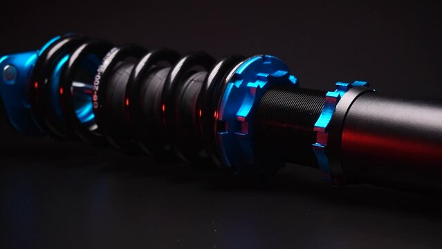 auto suspension tuning coilovers shock absorbers and springs blue for a sports drift car on a dark background