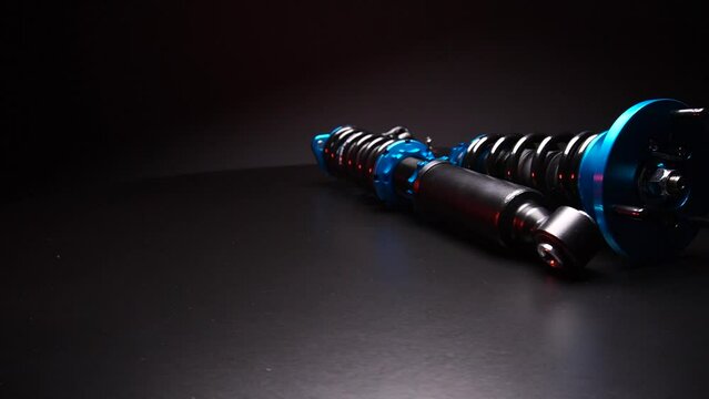 auto suspension tuning coilovers shock absorbers and springs blue for a sports drift car on a dark background