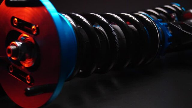 auto suspension tuning coilovers shock absorbers and springs blue for a sports drift car on a dark background