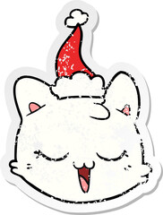 distressed sticker cartoon of a cat face wearing santa hat