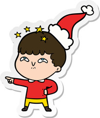 sticker cartoon of a amazed boy wearing santa hat