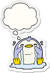 cartoon crying penguin and thought bubble as a printed sticker