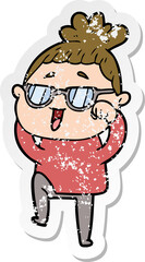 distressed sticker of a cartoon happy woman wearing spectacles