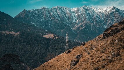 Mobile network tower with snow covered mountains in the background