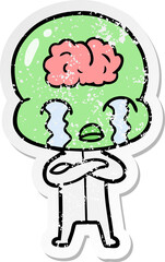 distressed sticker of a cartoon big brain alien crying