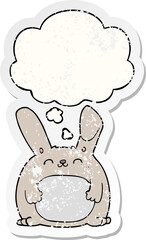 cartoon rabbit and thought bubble as a distressed worn sticker