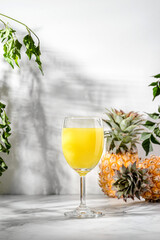 pineapple juice in a glass on a light table