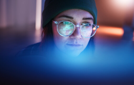Cybersecurity, database and woman hacker working on a computer in the basement at night for phishing. Malware, password and ransomware with a female coder hacking a digital transformation network
