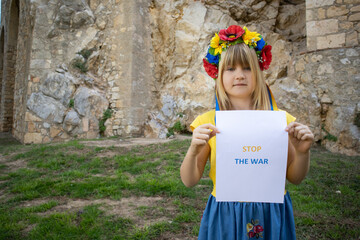 Ukrainian girl with a flower wreath on her head holding a 