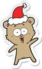 laughing teddy  bear sticker cartoon of a wearing santa hat