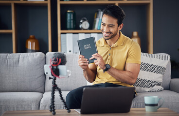 Bible, smile and man study with phone and microphone online live streaming. Asian male on home sofa with Christian religion book as blog or podcast content creator or influencer teaching or studying