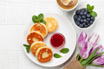 Cottage pancakes with jam, sour cream and berries