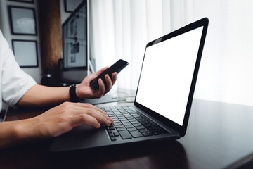 hands working on a laptop computer